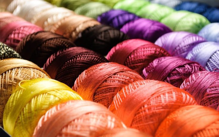 rolls of yarn in many different colors of the rainbow