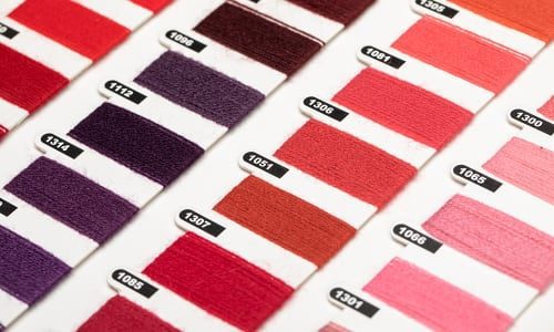 textile threads in reds and purples